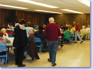 people at tables for pancake supper