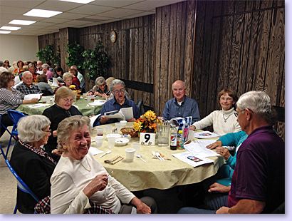 people at tables for church dinner